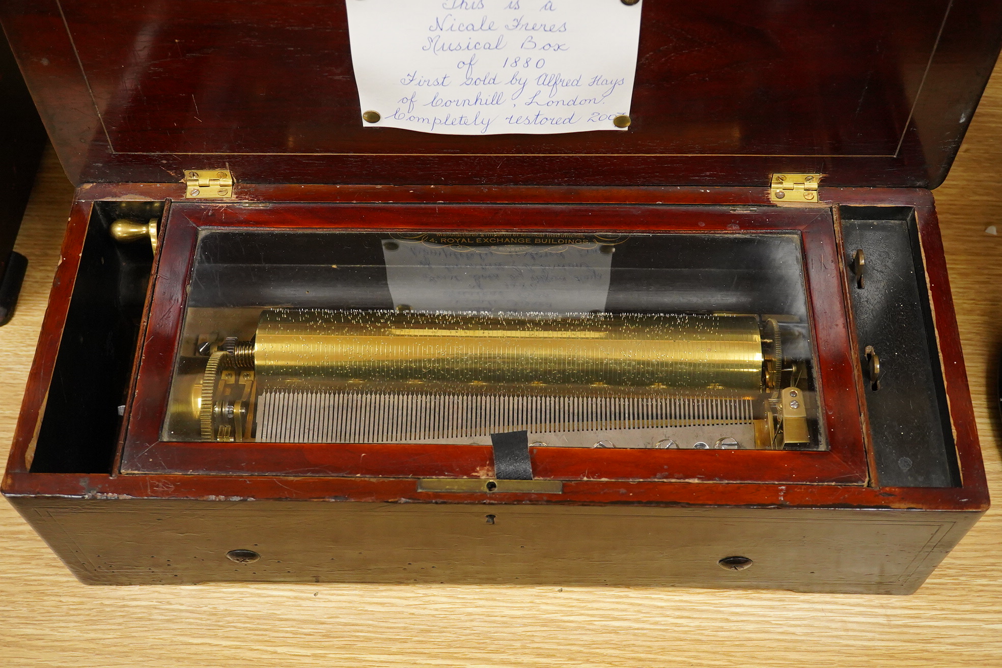 A late 19th century inlaid and ebonised rosewood Swiss cylinder music box by Nicole Freres, Geneve, and retailed by Alfred Hays, 4, Royal Exchange Buildings, complete with all teeth to the comb, cylinder 27.8cm long, the